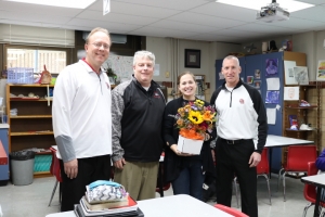DMS teacher Mary Sala presented with flowers for being named the Outstanding Art Teacher for 2019